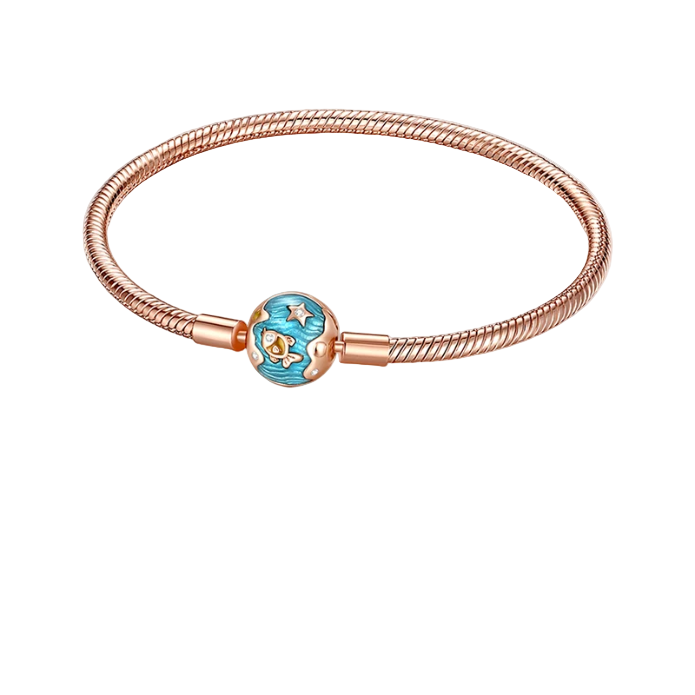 Rose gold bracelet with a blue heart charm on a pink background