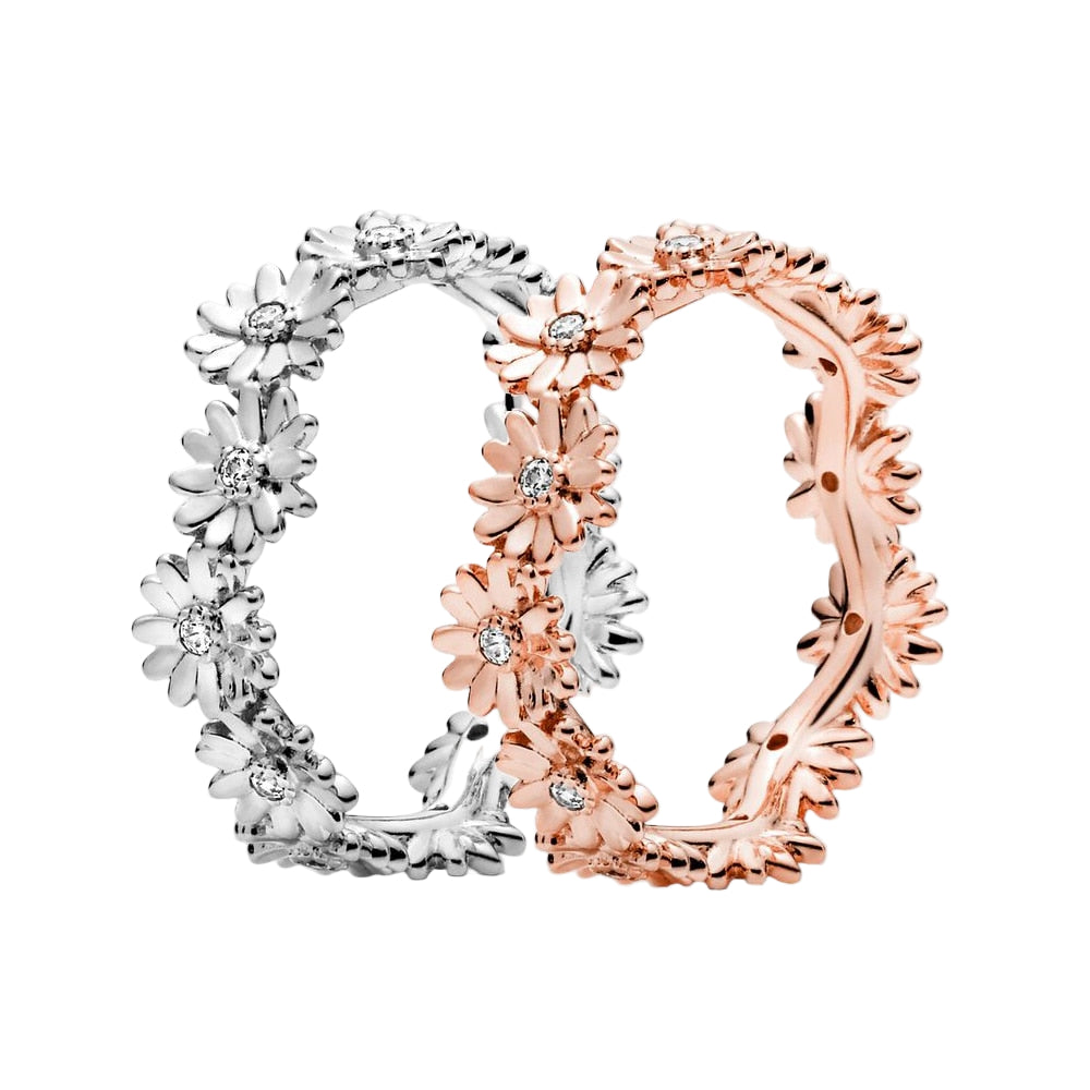 Two floral hoop earrings, one silver and one rose gold, on a white background.