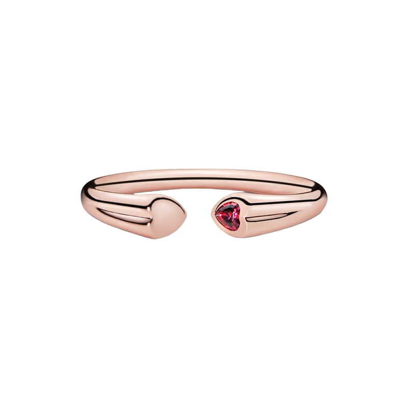 Rose gold open ring with a heart-shaped red gemstone on a white background